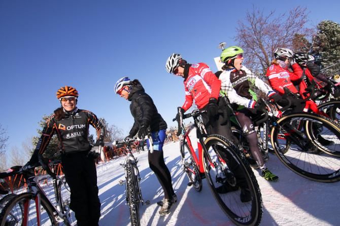 Riders try to stay warm before the start of their race.