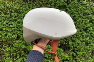 Male cyclist holding the Specialized Tone MIPS helmet