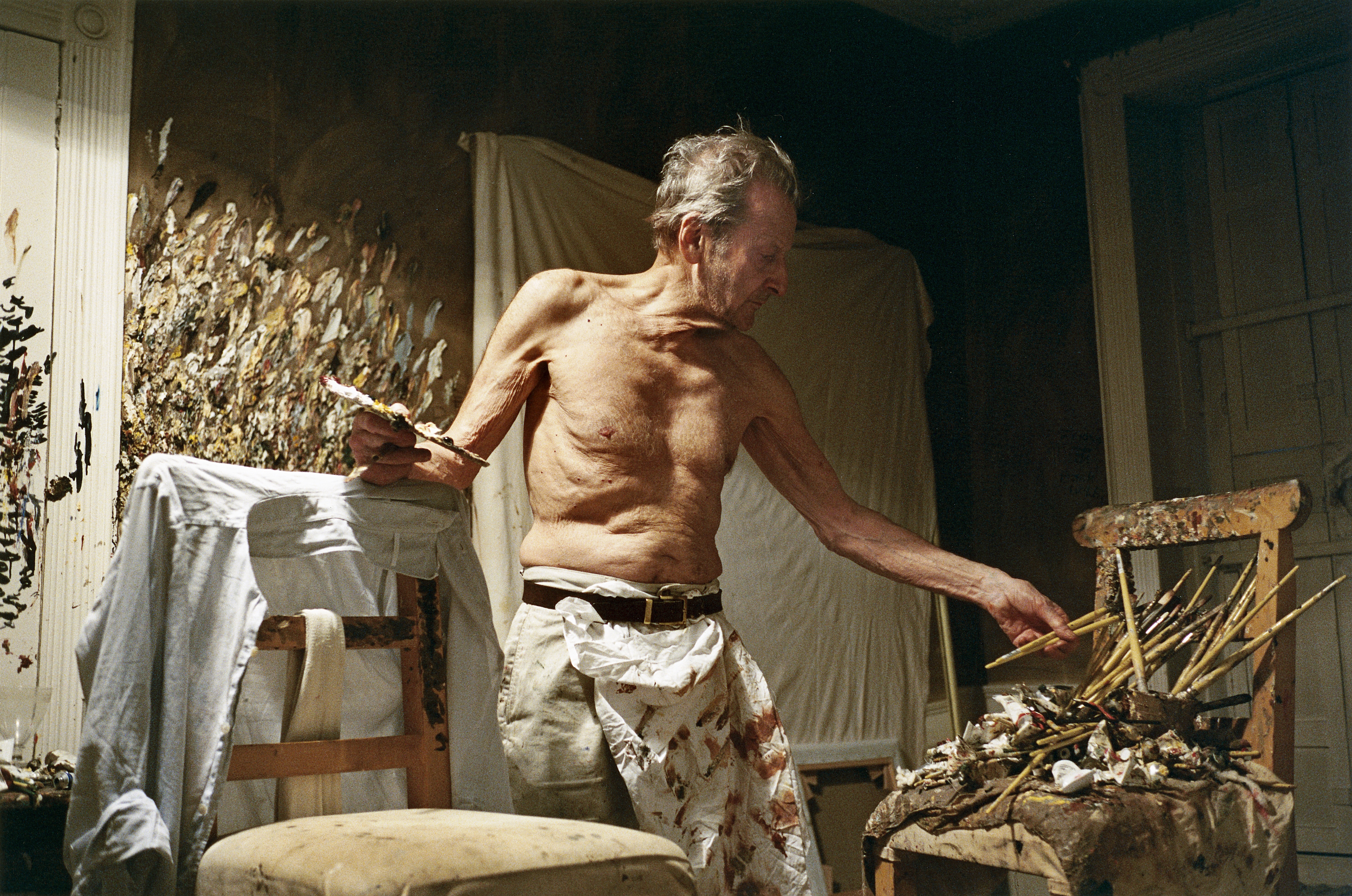 Lucien Freud in his studio, at nighttime, topless