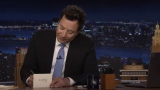 Jimmy Fallon writing out a Thank You note on The Tonight Show