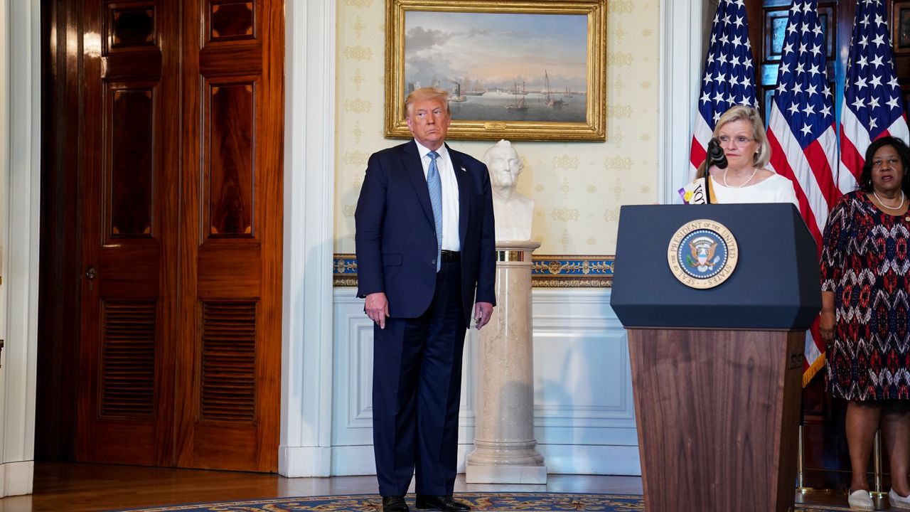 Cleta Mitchell, partner at Foley &amp; Lardner LLP, speaks during an event marking the 100th Anniversary of the 19th Amendment ratification with U.S. President Donald Trump, left, in the Blue Room of the White House in Washington, D.C., U.S., on Tuesday, Aug. 18, 2020