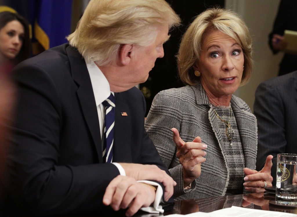 Betsy DeVos and Donald Trump.