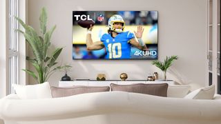TCL S450F TV on beige wall with NFL player on screen