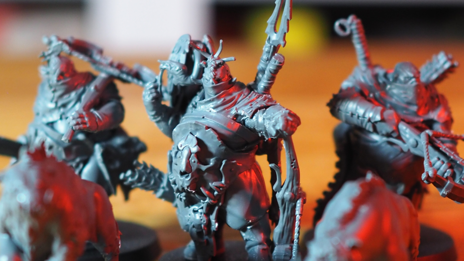 Ogor Mawtribes Hunters models on a wooden surface