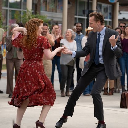 A woman (Annalise Basso) and a man (Tom Hiddleston) dance together in front of a crowd, in 'The Life of Chuck.'