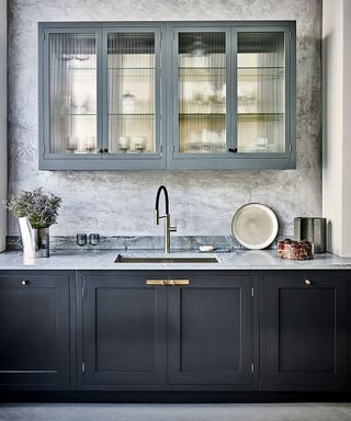 Modern kitchen with dark cabinets and fluted glass