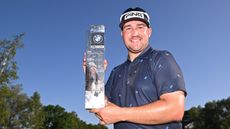 Thriston Lawrence holds up the 2023 BMW International Open trophy