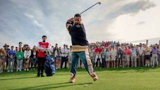 Adam Sandler as Happy Gilmore takes a swing in Happy Gilmore 2.