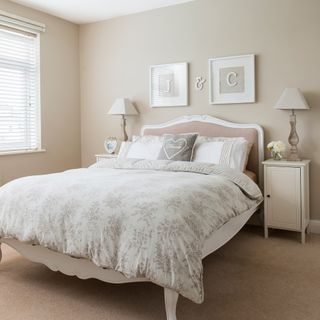 Neutral bedroom with white wooden bed
