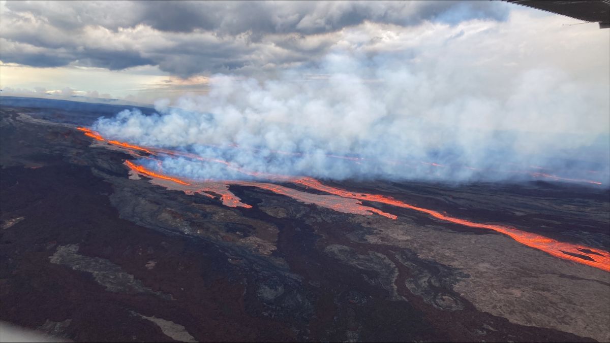 glowing lava flowing over landscape and smoke billowing off