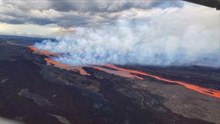 glowing lava flowing over landscape and smoke billowing off