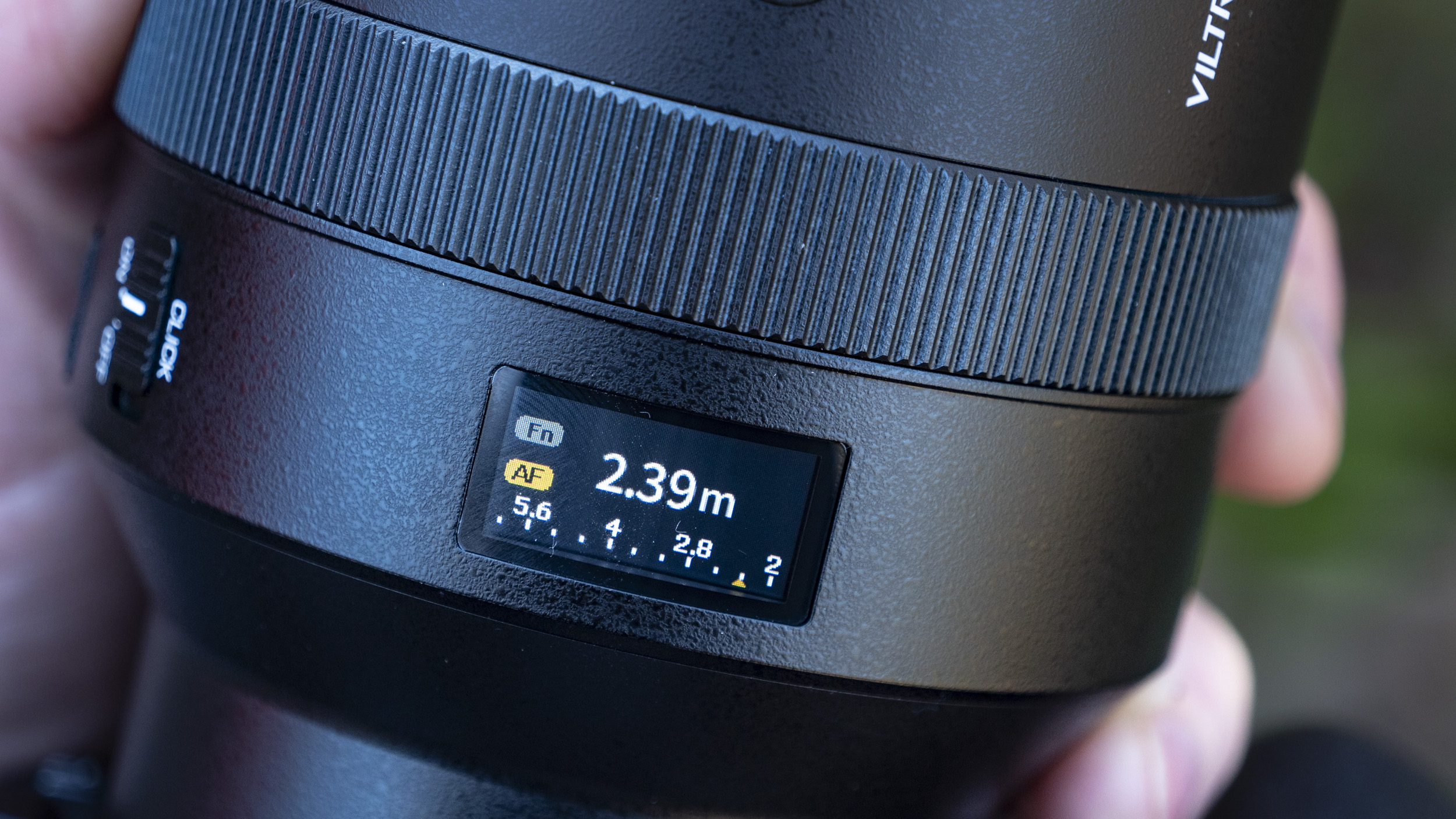 Close up of the Viltrox 135mm F1.8 Lab lens' LED display, with focus distance scale