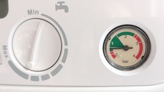 Close up of Baxi 600 combi boiler showing water temperature dial and pressure gauge