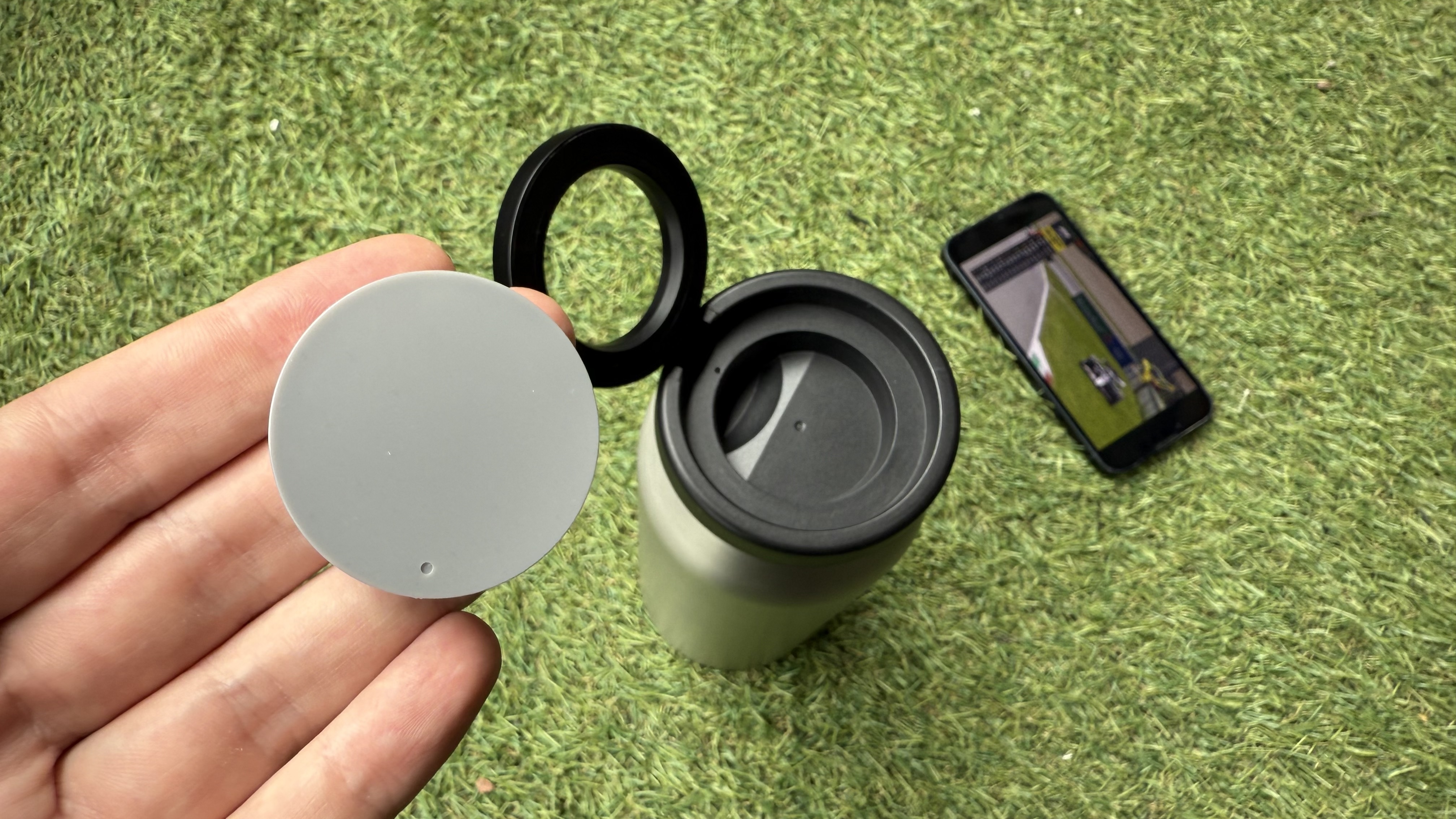 The Journey Reevus water bottle on a faux-grass surface