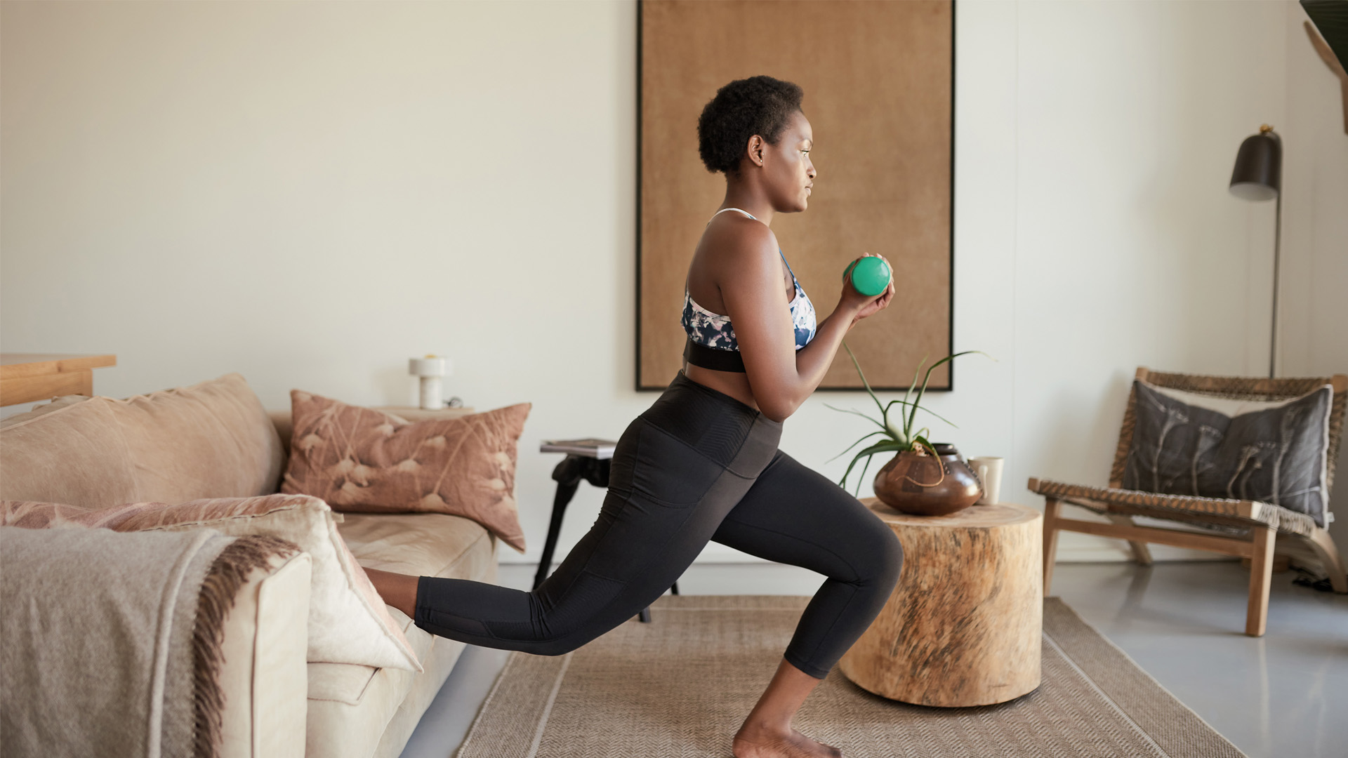 Image of a woman exercising with weights at home