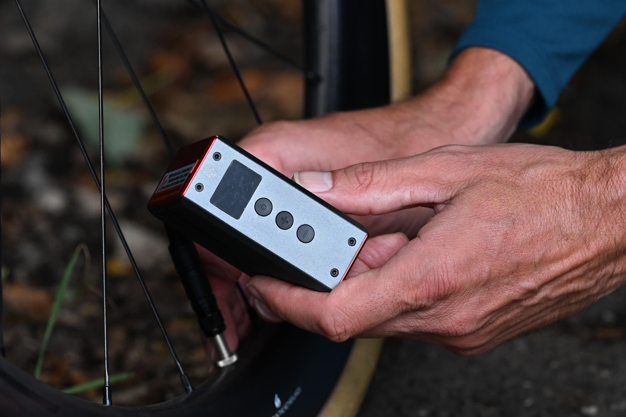 close up of a Silca Elettrico Ultimate Inflator being used to inflate a bike tyre