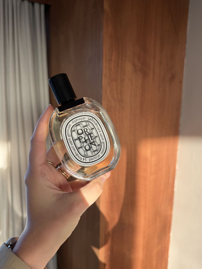 Shannon Lawlor holding Diptyque Orph&eacute;on Eau de Toilette