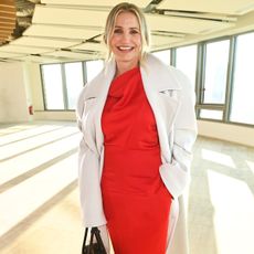 Cameron Diaz at PFW in a red dress and white coat