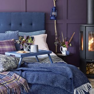 bedroom with purple wall and stove