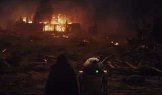 R2-D2 looks over flaming destruction the last jedi