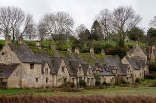 Row of the historic quintessential Cotswold cottages in Bibury, Gloucestershire