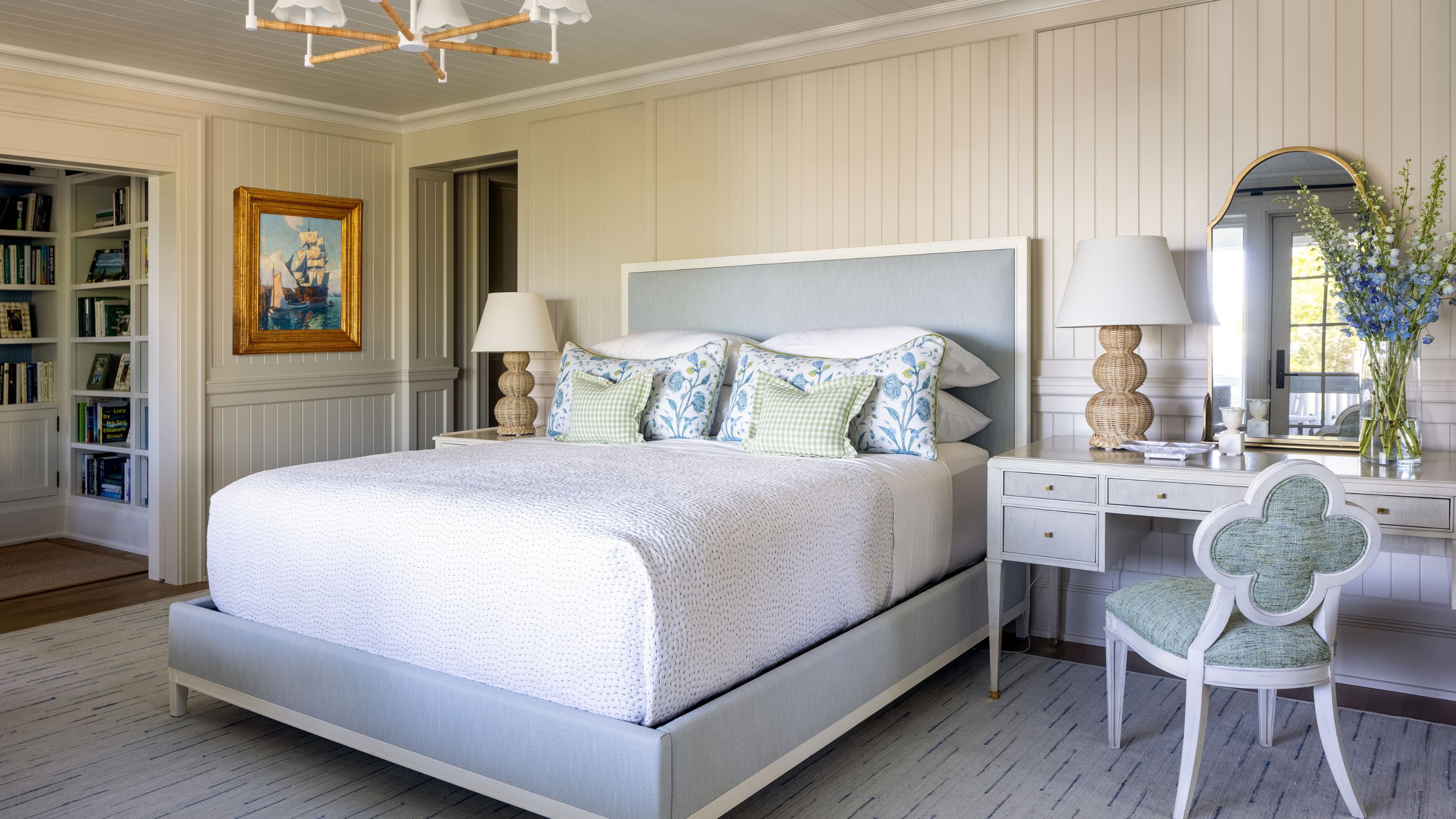 a light white and blue grey bedroom in a summer house with antiques and white furnishings