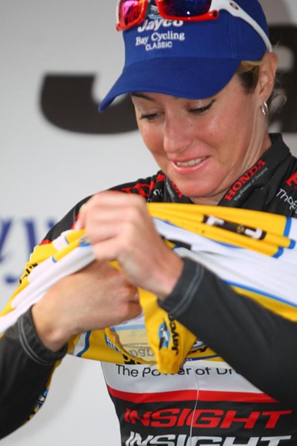 Rochelle Gilmore pulls on the leader's jersey which she has held throughout the series