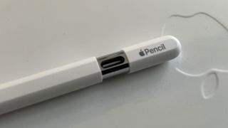 Apple Pencil USB-C on a white Magic Keyboard