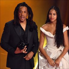 US rapper Jay-Z (L) accepts the Dr. Dre Global Impact Award alongside his daughter Blue Ivy on stage during the 66th Annual Grammy Awards