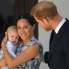 Meghan Markle holds son Prince Archie while Prince Harry looks on
