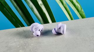 A pair of chilled lilac Bose QuietComfort Earbuds (2024)