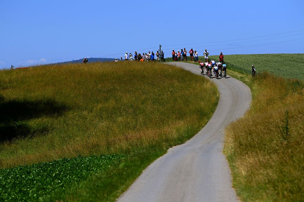 AESCH SWITZERLAND JUNE 13 A general view of Matthew Holmes of United Kingdom and Team Lotto Soudal Joel Suter of Switzerland and UAE Team Emirates Jonas Rutsch of Germany and Team EF Education Easypost Matteo Badilatti of Switzerland and Team Groupama FDJ Mathieu Burgaudeau of France and Team Total Energies Cees Bol of Netherlands and Team DSM Michael Schr of Switzerland and AG2R Citren Team and Leonardo Basso of Italy and Team Astana Qazaqstan compete passing through a landscape during the 85th Tour de Suisse 2022 Stage 2 a 198km stage from Kusnacht to Aesch ourdesuisse2022 WorldTour on June 13 2022 in Aesch Switzerland Photo by Tim de WaeleGetty Images