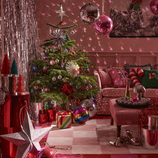 pink checkerboard floor. Green christmas tree with pink disco balls and baubles