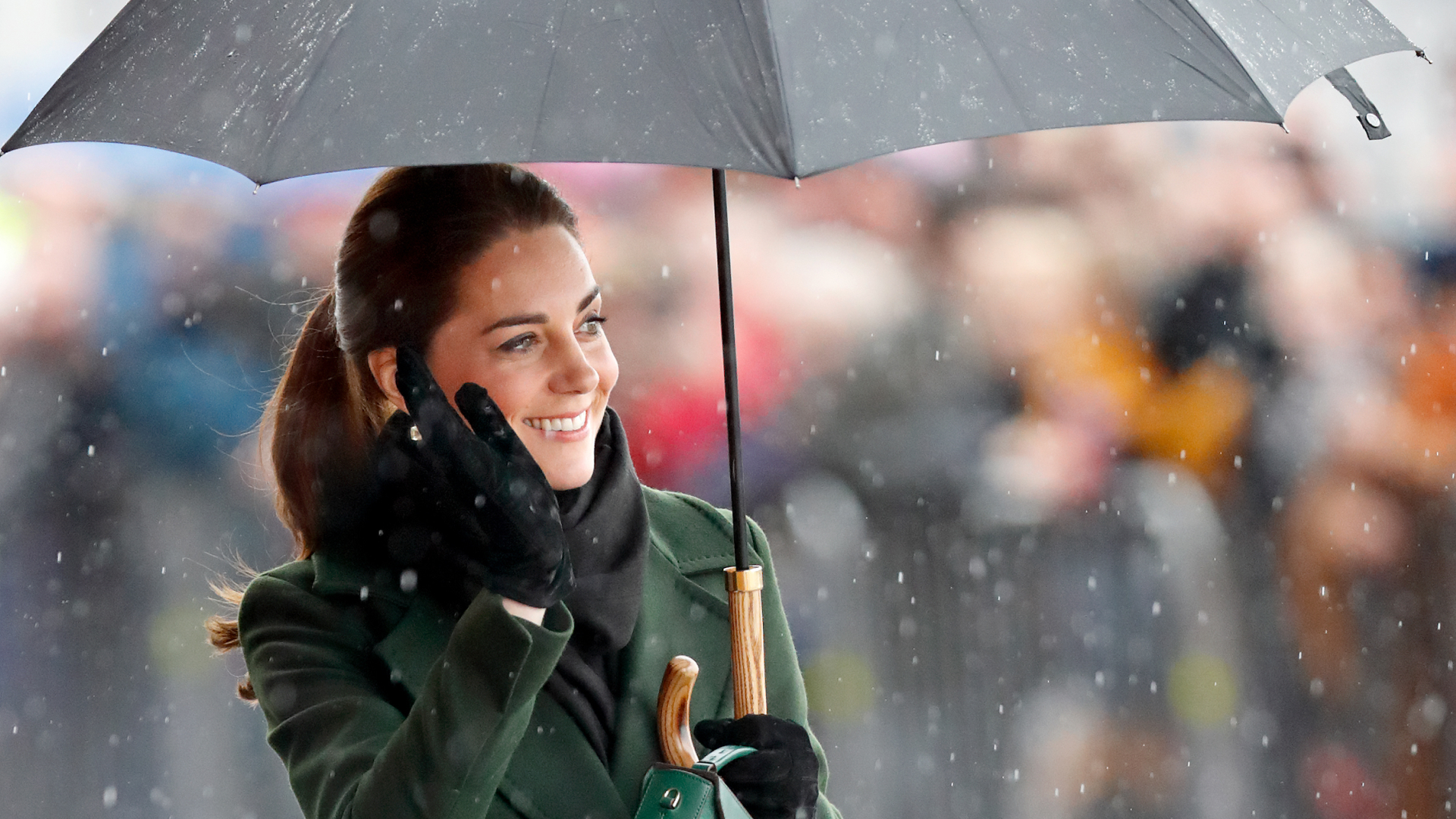 Princess Kate on a rainy day holding an umbrella