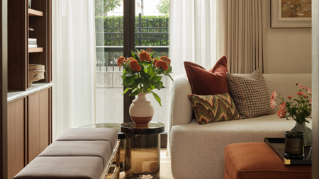a warm toned living room with sheer curtains