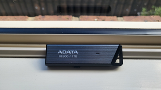 Adata UE800 1TB SSD on a window sill during our test and review process