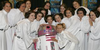 R2-KT pink droid surrounded by Princess Leias