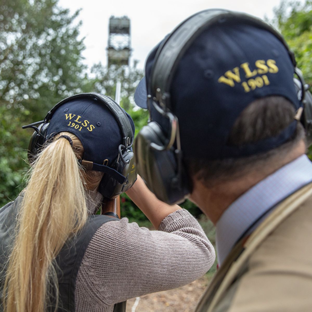 two people clay pigeon shooting