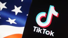 TikTok displayed on a smart phone with a USA flag in the background