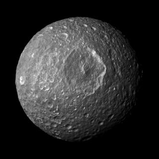 This mosaic, created from images taken by NASA's Cassini spacecraft during its closest flyby of Saturn's moon Mimas on Feb. 13, 2010, looks straight at the moon's Herschel crater and reveals new insights about the moon's surface. Herschel crater gives Mim