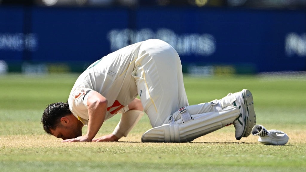 Travis Head, of Australia, kisses the turf after scoring a century on Day 3 of the 3rd Ashes Test against England in Adelaide.