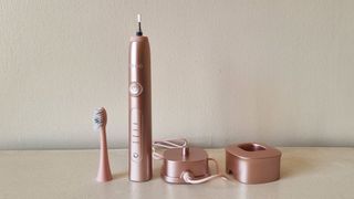 Ordo Sonic+ electric toothbrush (disassembled) with a charger