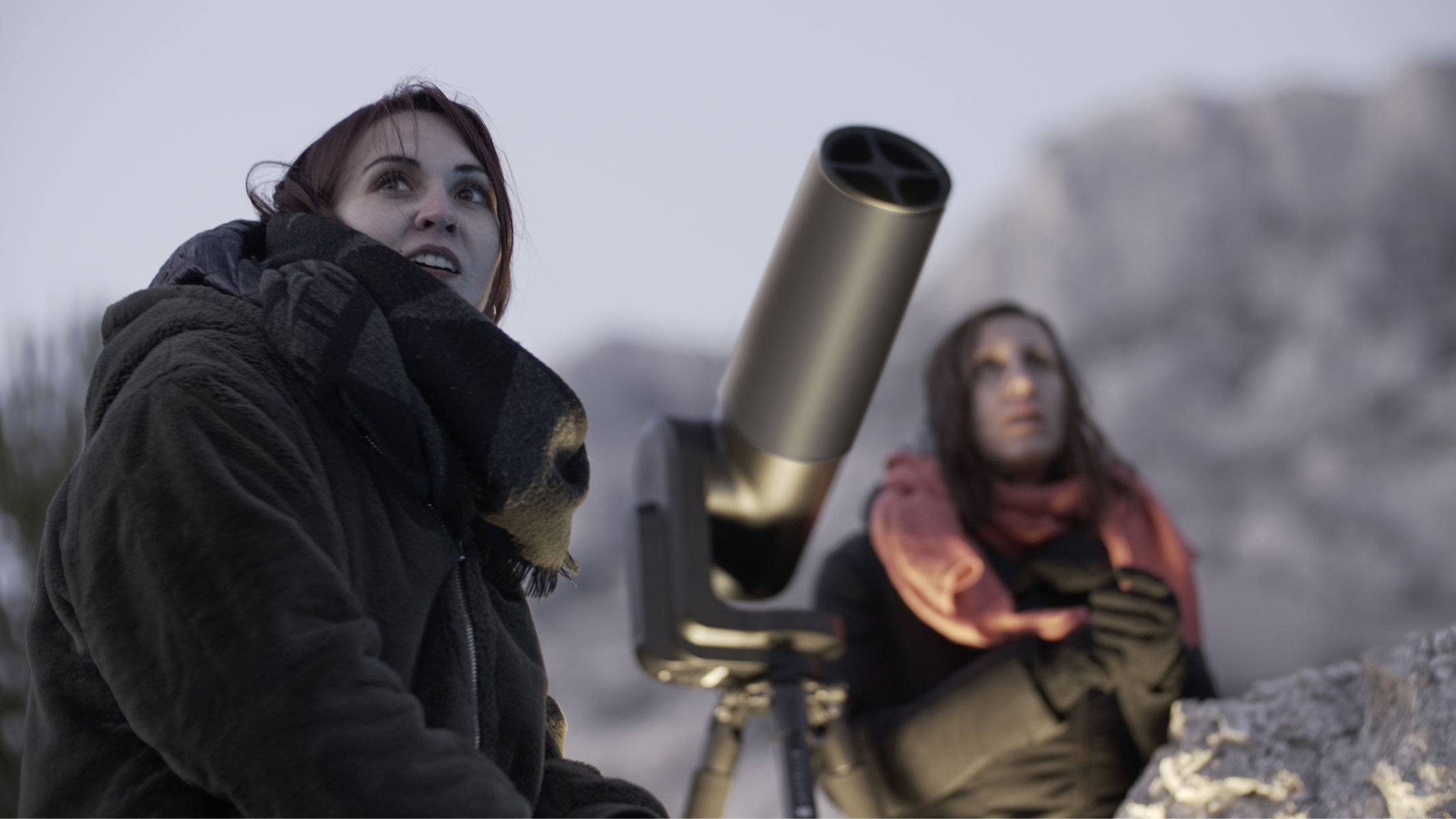 Two women using a Unistellar telescope.