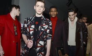 Male models posing in Versace