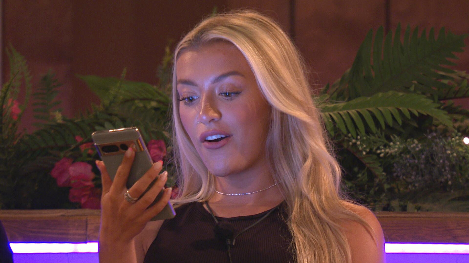 Molly reading a text on Love Island 2023