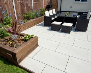 Backyard patio with light colored slabs