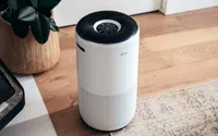 The Levoit Core 400S air purifier next to a houseplant.