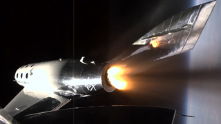 close up of spaceshiptwo firing its engines in space with earth visible as a blurry blue area to the right