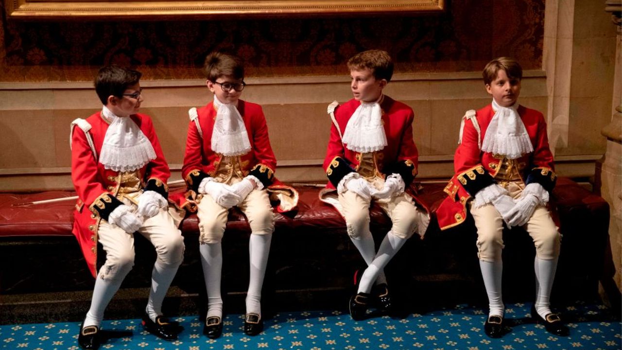 Page boys sit together before the arrival of Britain&#039;s Queen Elizabeth II in the Norman Porch at the Palace of Westminster for the State Opening of Parliament in the Houses of Parliament in London on October 14, 2019. - The State Opening of Parliament is where Queen Elizabeth II performs her ceremonial duty of informing parliament about the government&#039;s agenda for the coming year in a Queen&#039;s Speech. (Photo by Matt Dunham / POOL / AFP) (Photo by MATT DUNHAM/POOL/AFP via Getty Images)