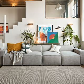 grey living room with grey modular sofa and modern artwork